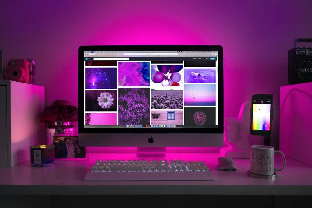 Computer displaying mood board for web development in pink